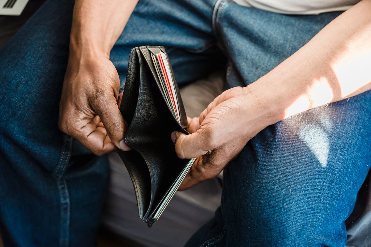 Empty wallet held open in someone's hands