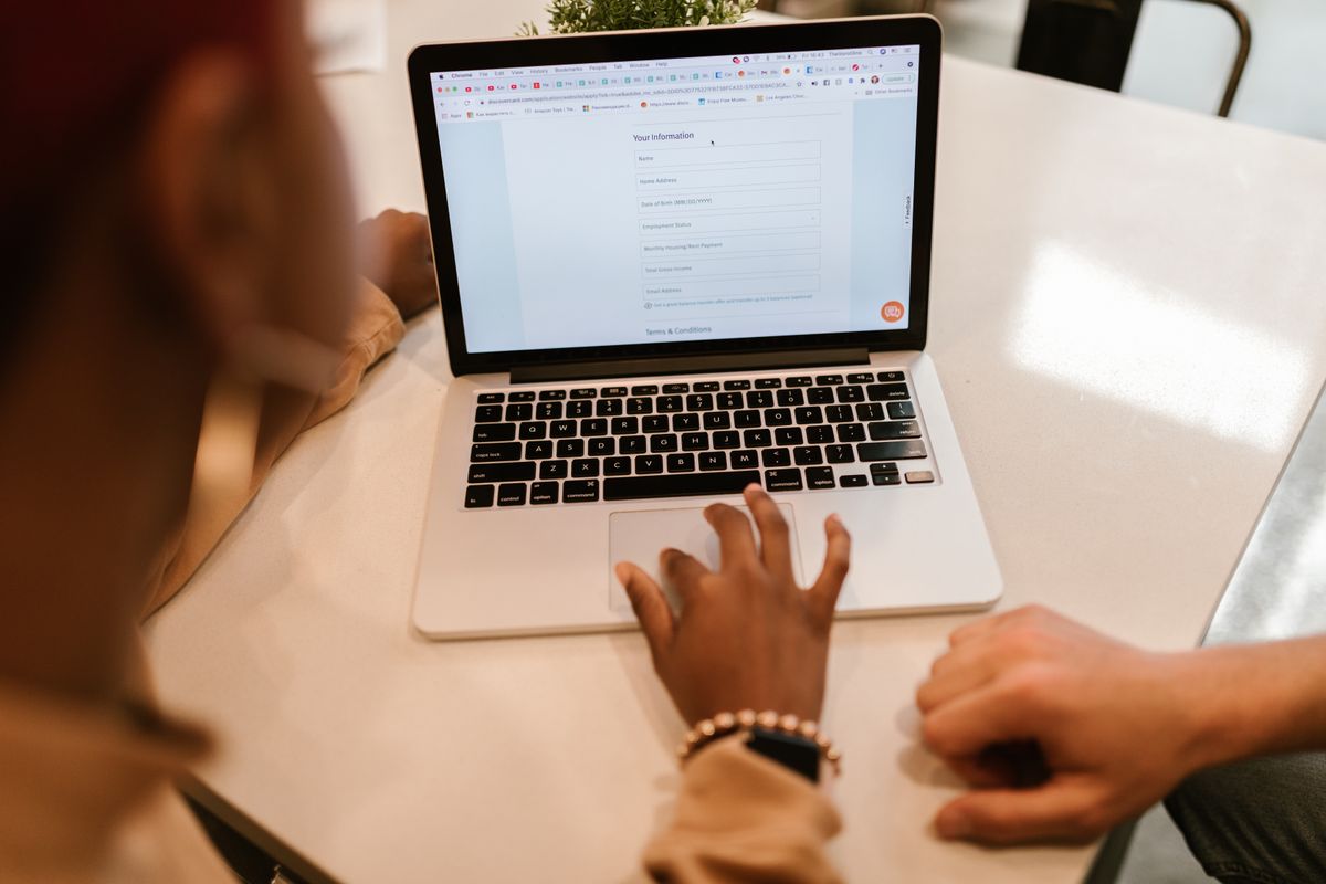 Person filling out an online form on a laptop