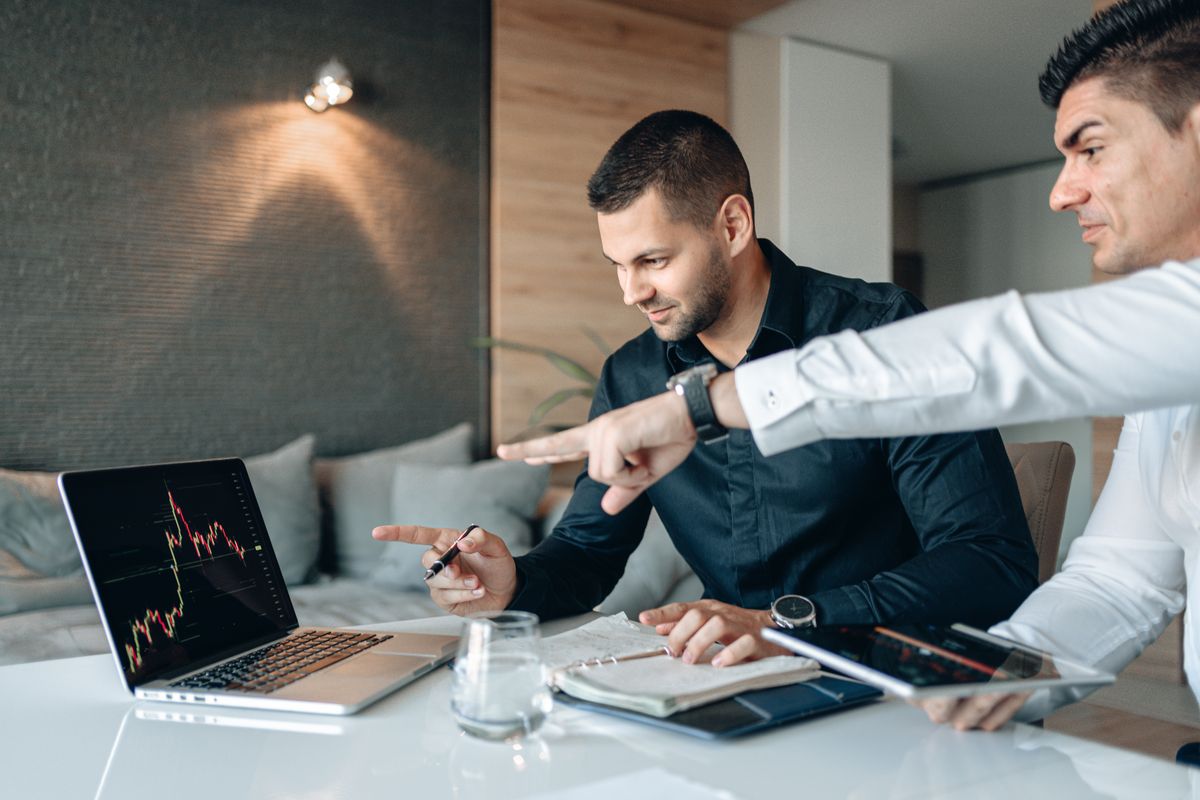 Two people reviewing plan options side by side on a laptop
